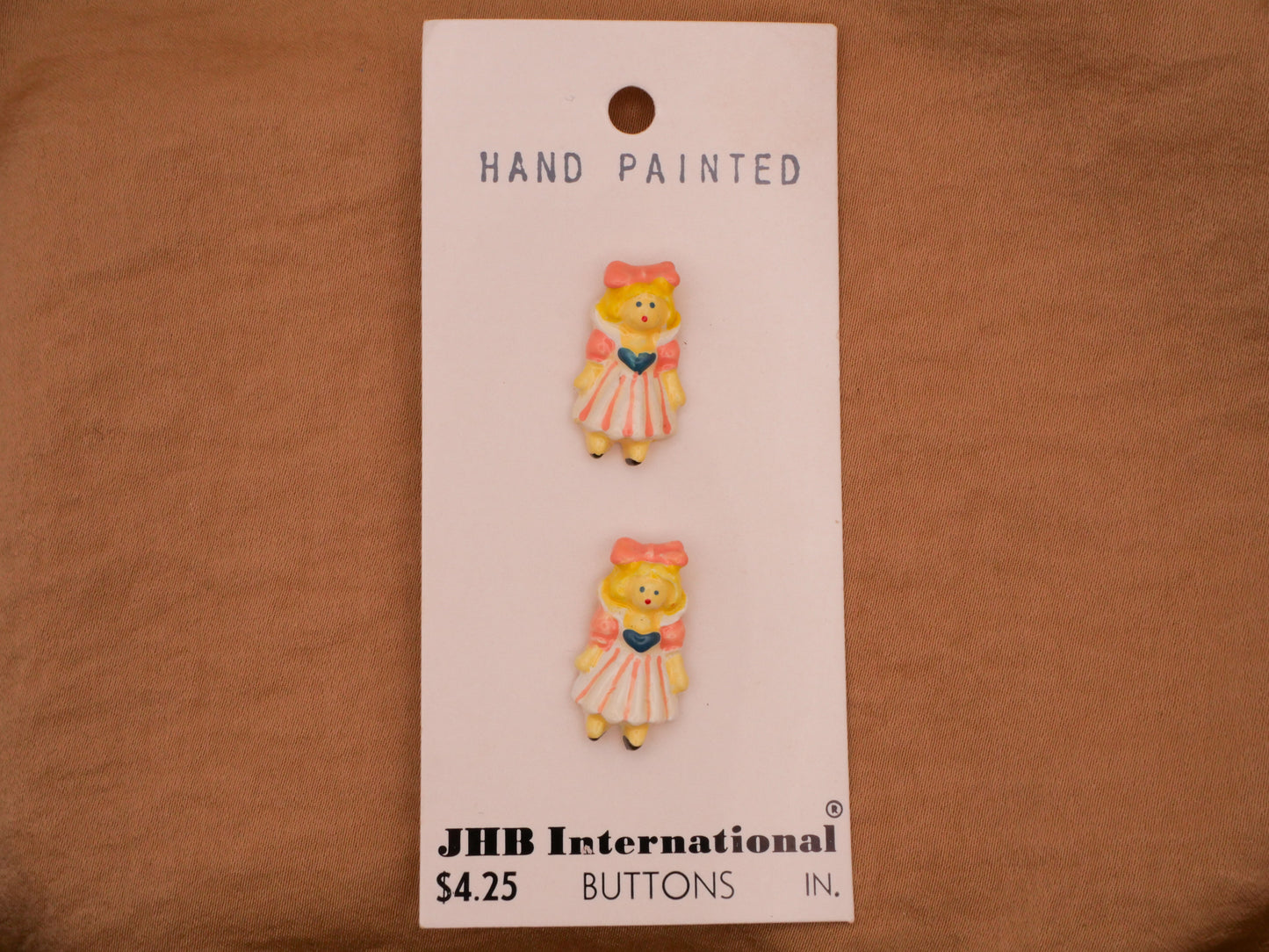 Girl Peachy Pink Bow Hand-Painted Enamel Metal JHB Carded Pair of Buttons 12x21mm