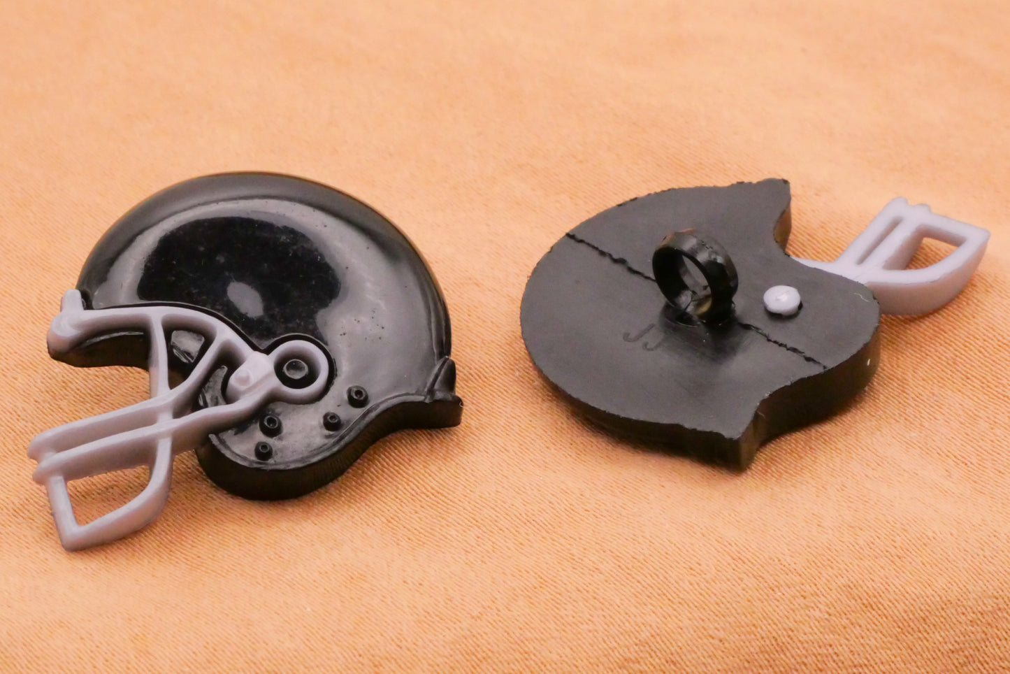 Football Helmet Black Plastic Pair of Buttons 21x24mm